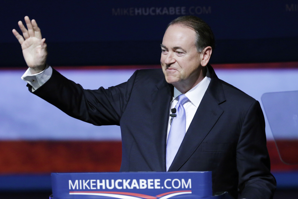 Former Arkansas Gov. Mike Huckabee waves to supporters in Hope, Ark., Tuesday, after he announced that he is running for the Republican presidential nomination.