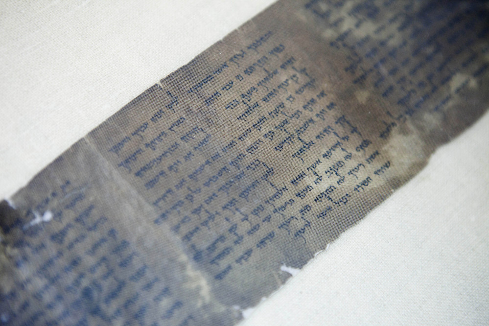 FILE - This Friday, May 10, 2013 file photo shows the world's oldest complete copy of the Ten Commandments, written on one of the Dead Sea Scrolls in Jerusalem. The manuscript is on rare display at Israel's national museum in an exhibit of objects from pivotal moments in the history of civilization. (AP Photo/Dan Balilty, File)