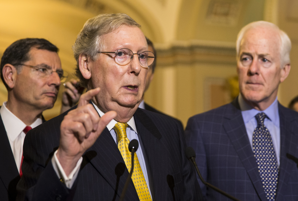 Senate Majority Leader Mitch McConnell of Kentucky, with Sen. John Barrasso, R-Wyo., left, and Senate Majority Whip John Cornyn, R-Texas, talks with reporters Wednesday on Capitol Hill.