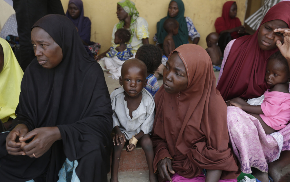 Women and children rescued by Nigerian soldiers from Boko Haram extremists  wait for treatment at a refugee camp in Yola, Nigeria, on Monday.