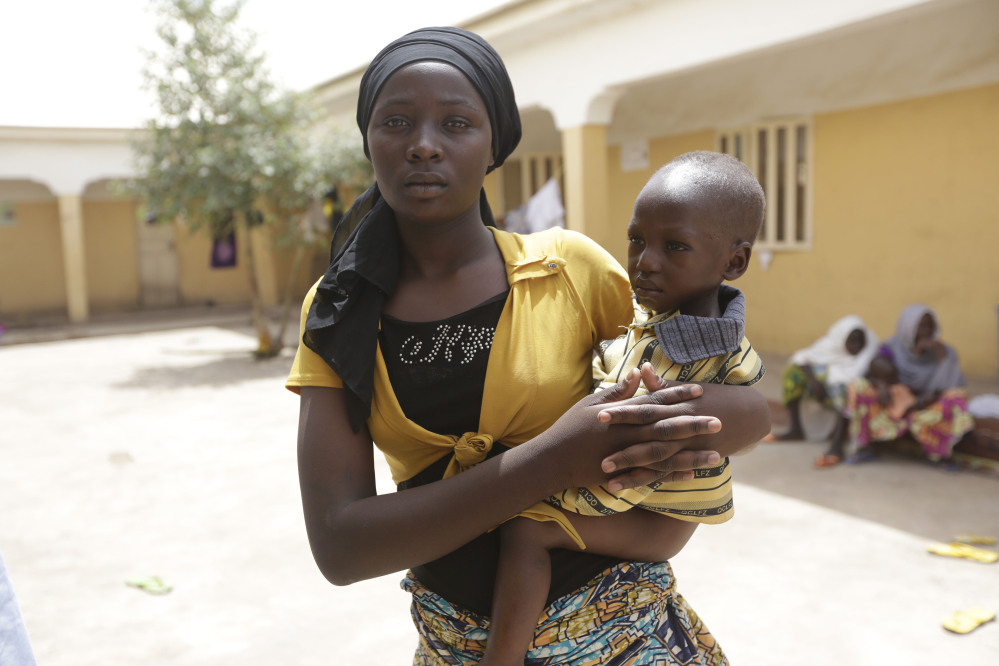 A recent hostage, Binta Ibrahim holds an unidentified baby in a refugee camp while describing how she fled a Boko Haram hideout in Nigeria’s Sambisa Forest, where the Islamic militants are now being pounded by air raids. With Chad and Cameroon assisting their Nigerian neighbor, Boko Haram is growing weaker by the day.