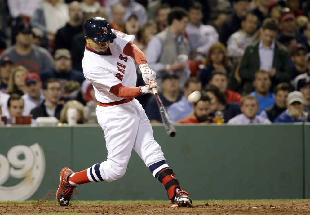 Mookie Betts hits the second of his two solo home runs Tuesday night against the Tampa Bay Rays, in the eighth inning. The two home runs accounted for all of the scoring in the game.