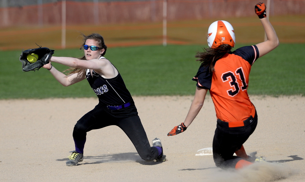 Jocelyn Moody of Biddeford slides safely into second with a stolen base Wednesday as Meaghan Sandler of Marshwood collects the throw during Biddeford’s 11-2 victory in an SMAA softball game at Biddeford.