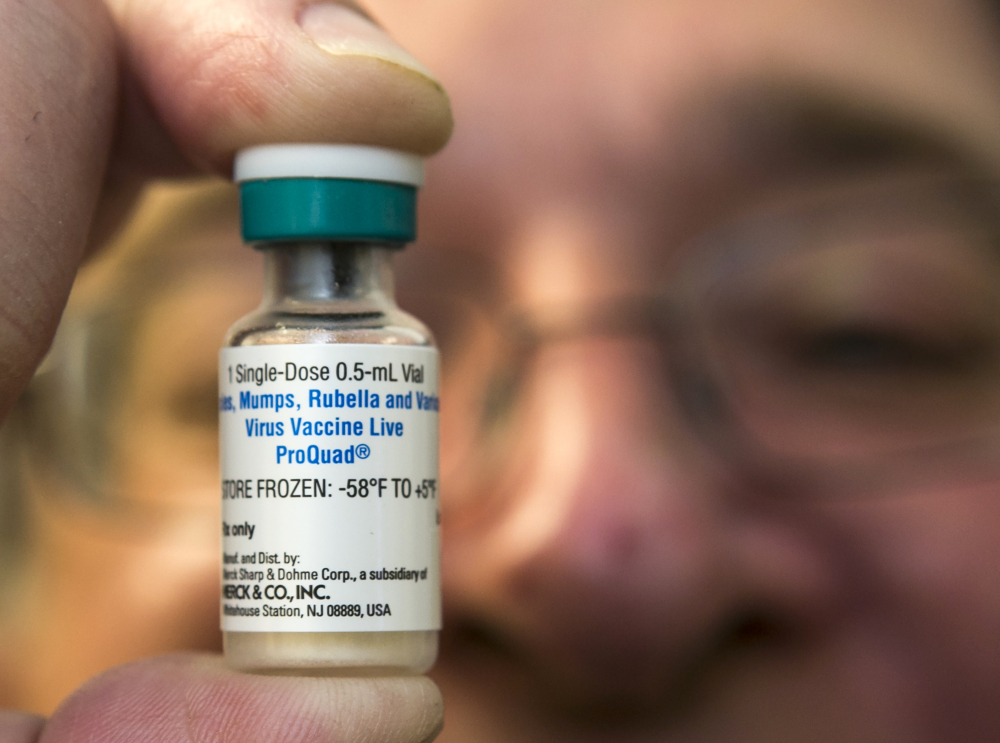 A pediatrician holds a dose of the measles-mumps-rubella (MMR) vaccine. A new study published in the journal Science suggests the measles vaccine not only prevents measles, but may also help the body ward off other infections.