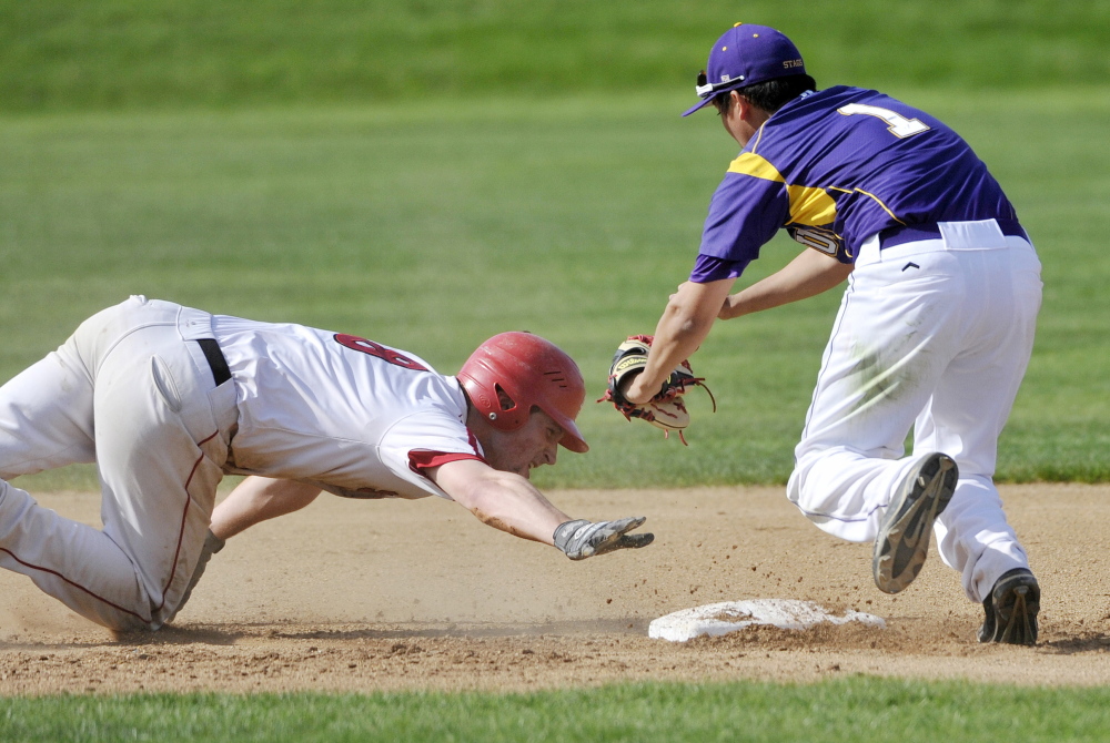 Cheverus second baseman Matt Gedaro readies to tag out Zach Carreiro of Scarborough, who slid past second base on a steal attempt Thursday during the second inning of Cheverus’ 7-1 victory at home.
