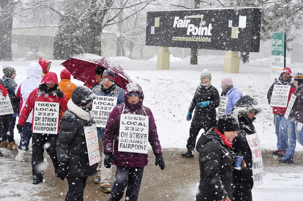 Striking employees picket in front of FairPoint Communications’ Portland offices Jan. 24. The four-month work stoppage over issues including outsourcing resulted in “a more secure future for Maine workers,” a reader says.