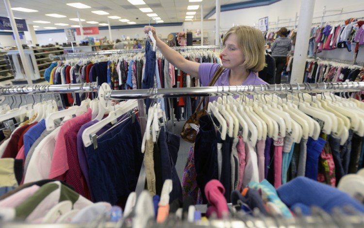 Brandis Peterson of Scarborough shops for clothes Friday at the Goodwill store on Forest Avenue in Portland.