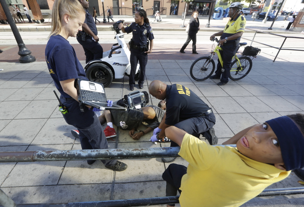 First responders attend to a "synthetic marijuana" victim in Dallas in 2014. The man had smoked K2, also known as "spice," known to cause  hallucinations and violent behavior.