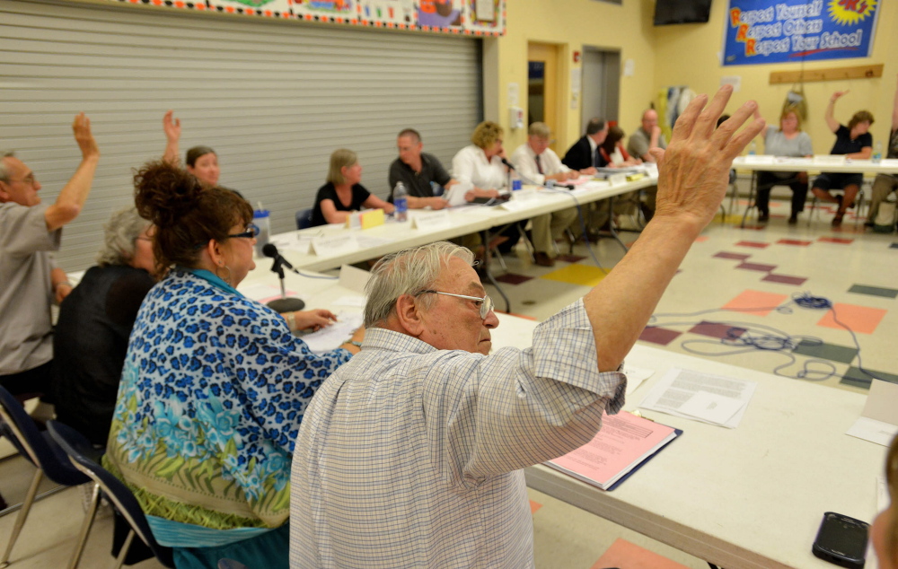 Allan Laney, a member of the School Administrative District 54 board, votes to keep the Skowhegan Area High School team name “Indians” during a board meeting Thursday at Skowhegan Junior High School. A proposed name change was voted down.
