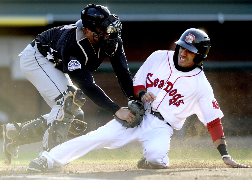 Carlos Asuaje of the Portland Sea Dogs is tagged out by New Britain catcher Tommy Murphy in the first inning Friday night. Asuaje had doubled, then was thrown out by shortstop Trevor Story after a single by Oscar Tejeda.