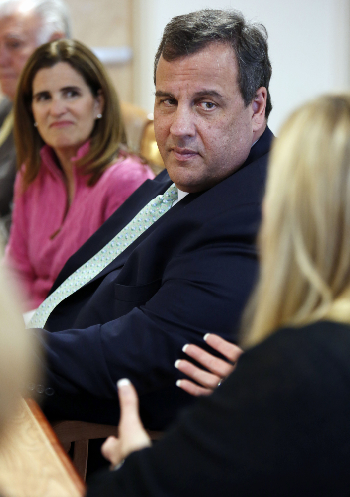 New Jersey Gov. Chris Christie and his wife, Mary Pat, left, listen to Melissa Crews during a stop Thursday at the Farnum  Center in Manchester, N.H.