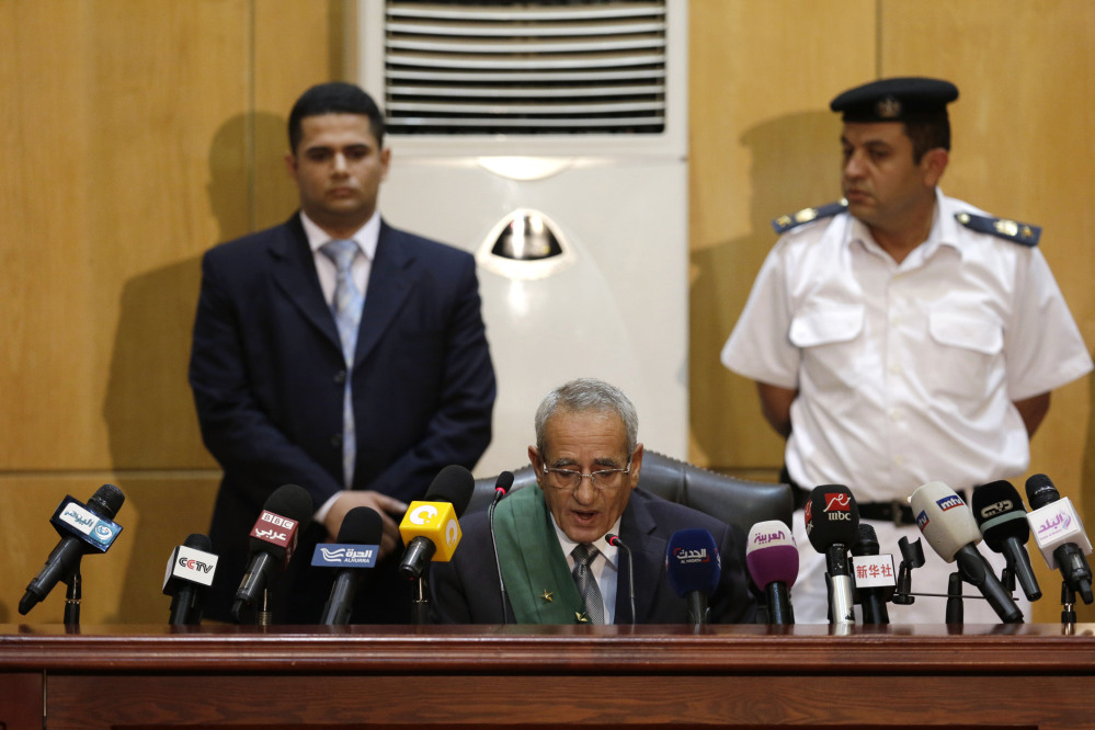 Egyptian Judge Hassan Hassanin reads the verdict of the corruption case dubbed by the Egyptian media as the “presidential palaces” affair concerning charges that former Egyptian President Hosni and his two sons Gamal and Alaa Mubarak, embezzled millions of dollars’ worth of state funds over the course of a decade in a courtroom in Cairo, Egypt, on Saturday.