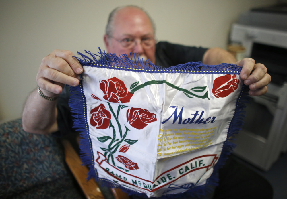 Donald Lamoureux displays a pillow sham, which his son bought on eBay, at a senior center May 5 in Millville, Mass. Dominic O’Gara, an artilleryman who served in Italy during World War II, had mailed the sham from an Army base in California to his mother in Millville in 1942.