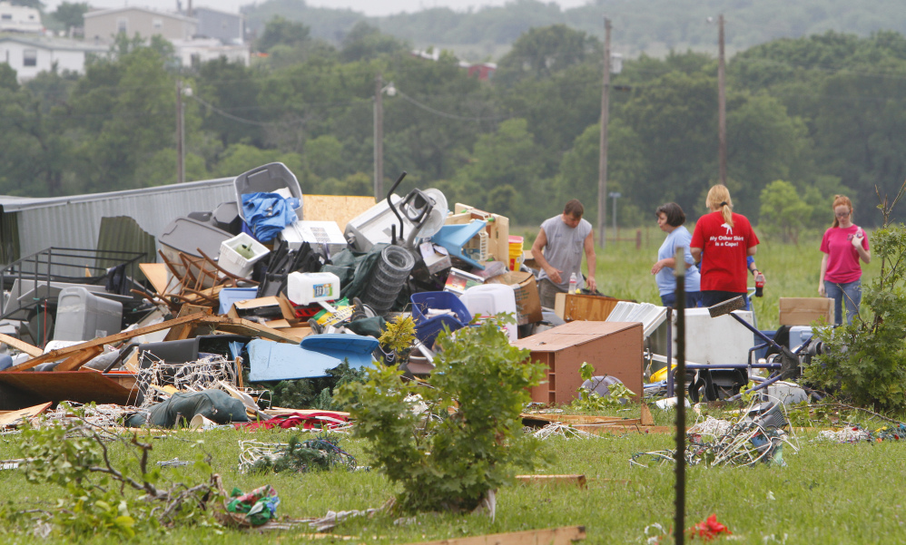 Neighbors and friends help clean up Friday after a tornado passed through New Fairview, Texas, on Thursday night. Severe weather continued in North Texas on Saturday, when multiple tornadoes left one person dead and others unaccounted for.