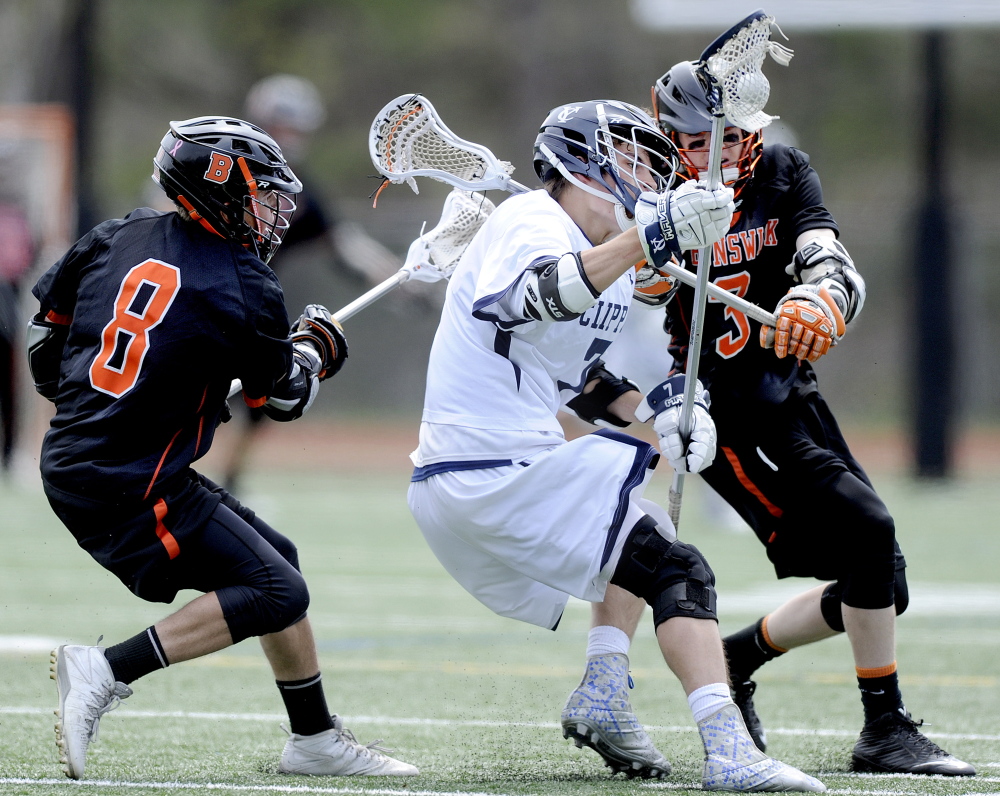 Henry Oliva of Yarmouth is double-teamed by Brunswick’s Kyle Woodruff, left, and T.J. Sullivan during their boys’ lacrosse game Saturday in Yarmouth.