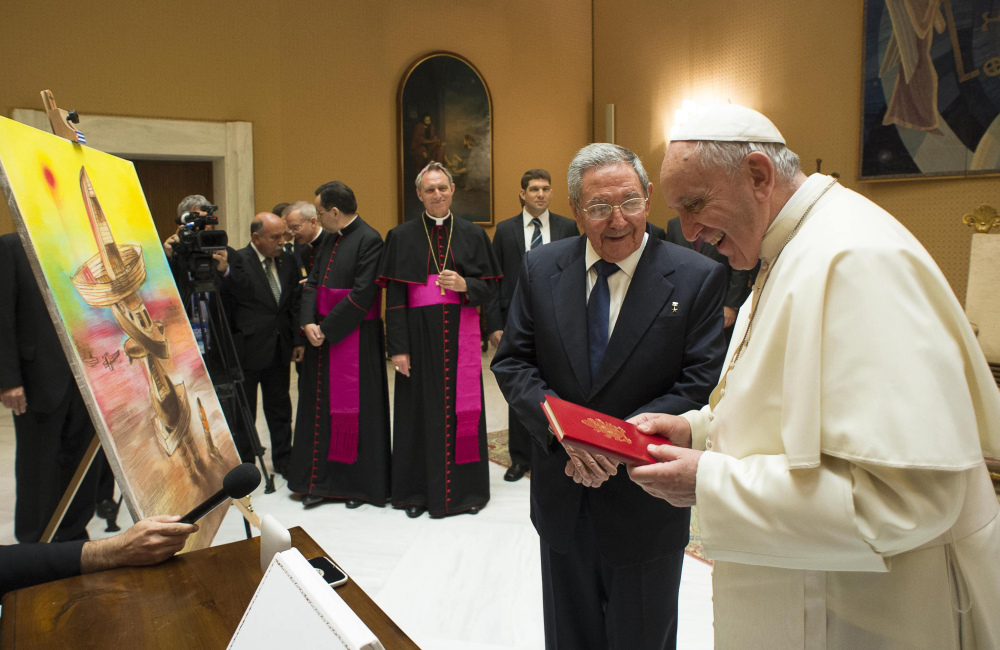 Cuban President Raul Castro exchanges gifts with Pope Francis at the Vatican on Sunday. Castro paid the visit on his way back from Moscow to thank the pontiff for working toward improved relations between Cuba and the United States.