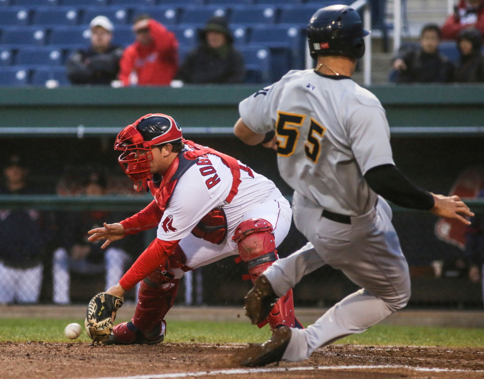 Sea Dogs catcher Tim Roberson catches the ball while Aaron Judge is safe at home.
Whitney Hayward/Staff Photographer