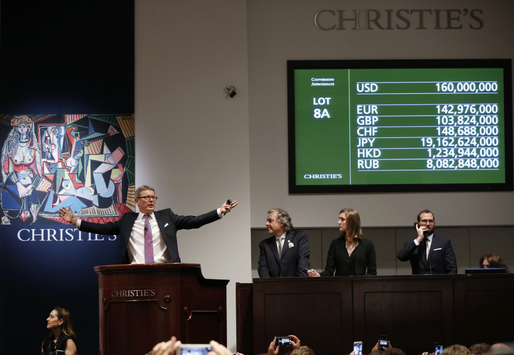 Auctioneer Jussi Pylkkanen takes bids for Pablo Picasso’s “Women of Algiers (Version O),” during Monday’s auction at Christie’s Rockefeller Center in New York.