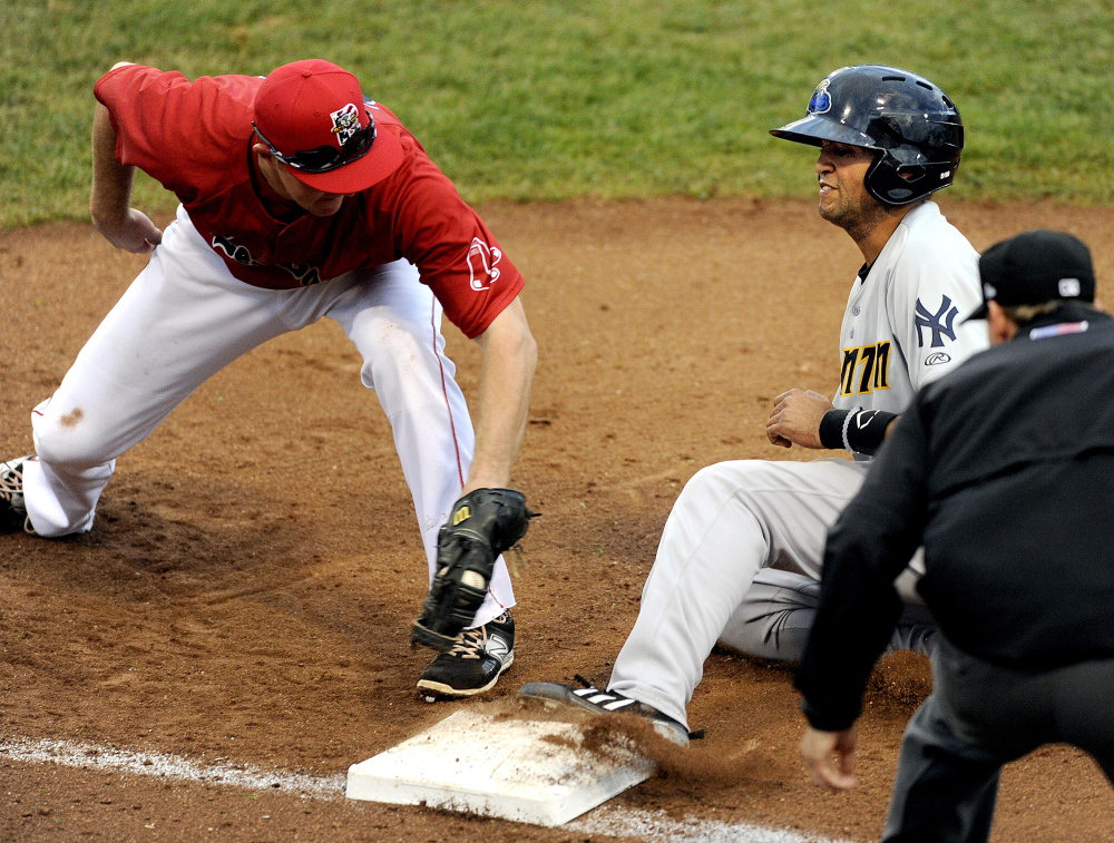 Portland’s Jantzen Witte applies the tag a split second too late to get Trenton baserunner Mason Williams on a pickoff attempt by Portland catcher Luis Martinez during the Sea Dogs’ 6-3 loss Tuesday at Hadlock Field.