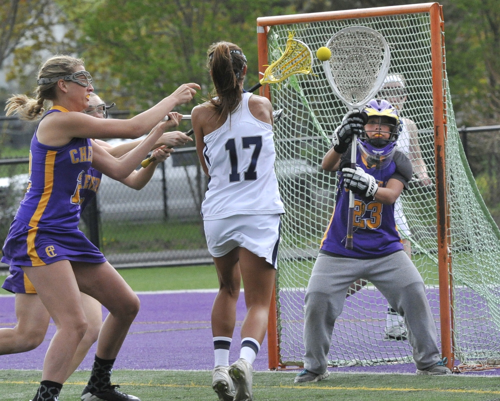 Isabel Stehli of Portland takes a shot on Cheverus goalkeeper Hope Correia during their girls’ lacrosse game Tuesday at Deering High. Cheverus scored with 22 seconds left for a 10-9 victory that improved its record to 3-2. Portland is 2-3.
