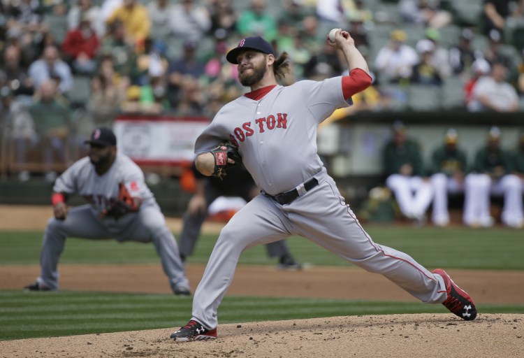 Red Sox starting pitcher Wade Miley throws in the first inning Wednesday against the Oakland Athletics. Needing a strong start, Miley held the A’s scoreless on just five hits.