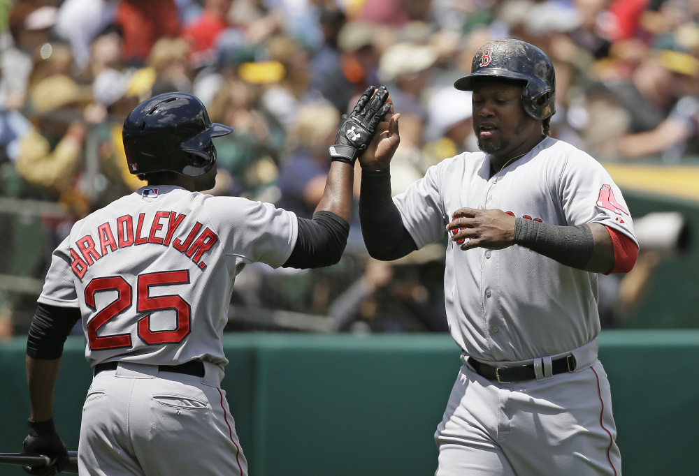 Boston’s Hanley Ramirez, right, is greeted by teammate Jackie Bradley Jr., as he scores the Red Sox’ first run of the game, in the second inning.
