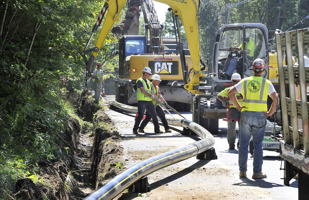 Subcontractor crews get a pipe into position for burial in a trench along Route 88 in Cumberland last year. Summit Natural Gas of Maine says it didn’t anticipate how little Mainers knew about natural gas when it arrived here in 2012.