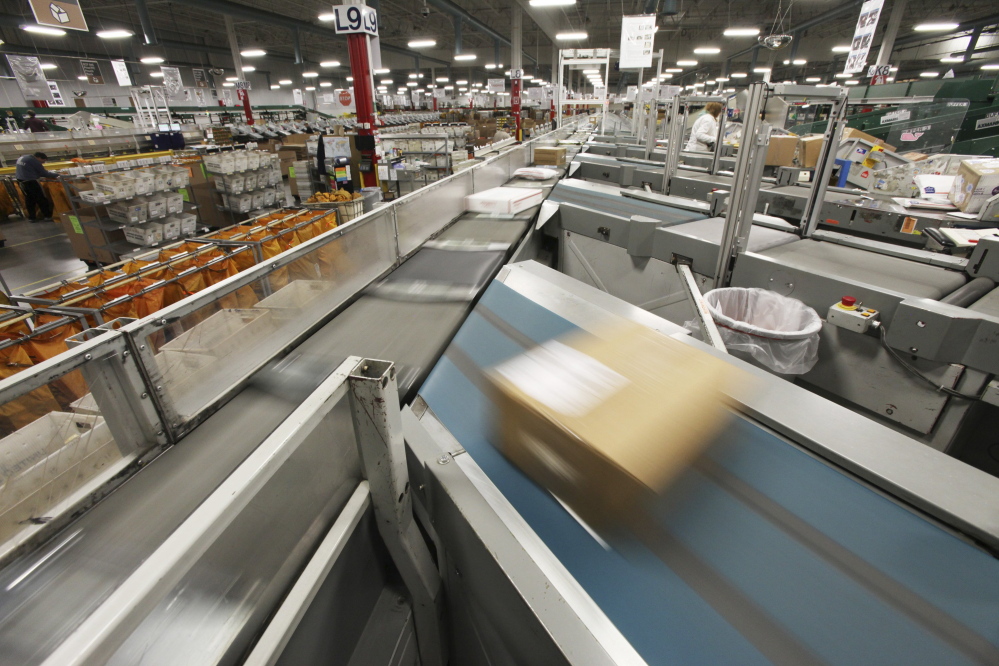 Packages are sorted at the postal distribution center in Scarborough in 2014. Workers in the center say the Postal Service’s decision to relocate one of the plant's Automated Parcel Bundle Sorters to Nashua, New Hampshire, will delay mail deliveries and reduce service in southern Maine.