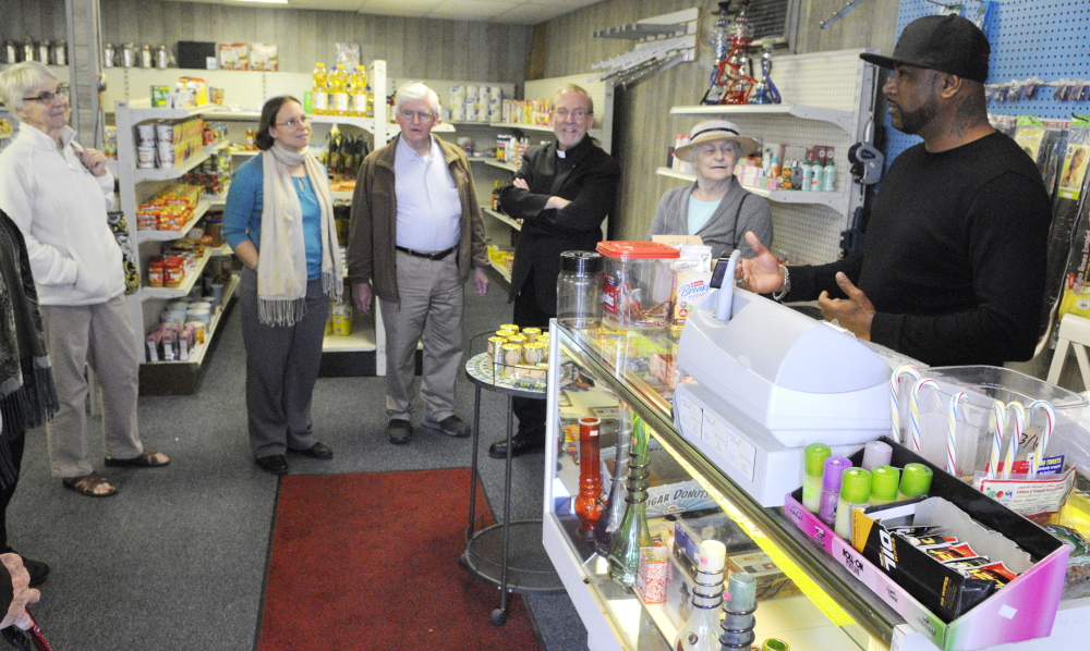 Members of the Capital Area Multifaith Association visited Mainly Groceries in Augusta Wednesday to show support for the store’s owners. Sosa Sosa, right, an Iraqi native working at the store, said the visit was a sign things ”are going to be good.”