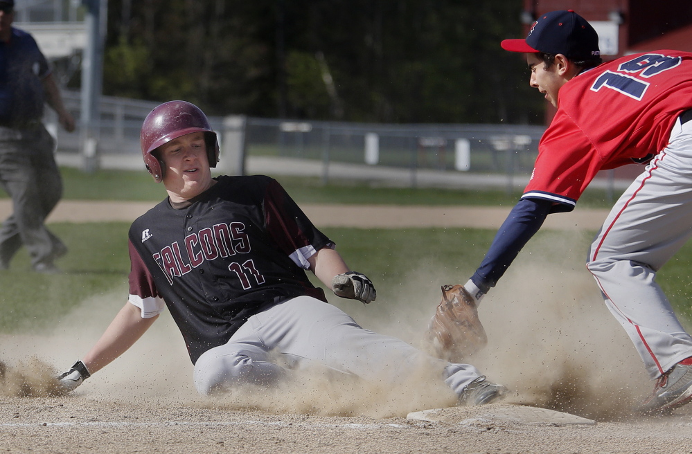 Peter Lamagna of Freeport slides safely into third with a stolen base Wednesday, beating a tag by John Villanueva of Gray-New Gloucester during Freeport’s 4-2 victory.
