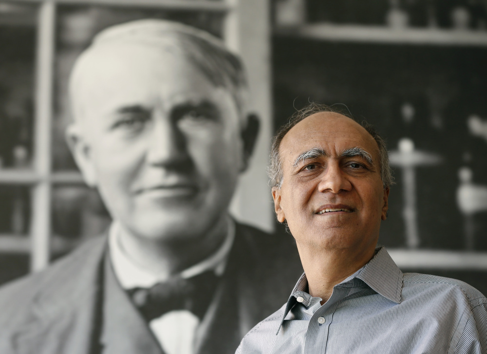 General Electric Chief Scientist Krishan Luthra poses in front of a Thomas Edison photo at GE Global Research in Niskayuna, N.Y. Luthra’s nearly 30-year effort to invent a tough, light material has attracted aircraft engine orders worth billions.