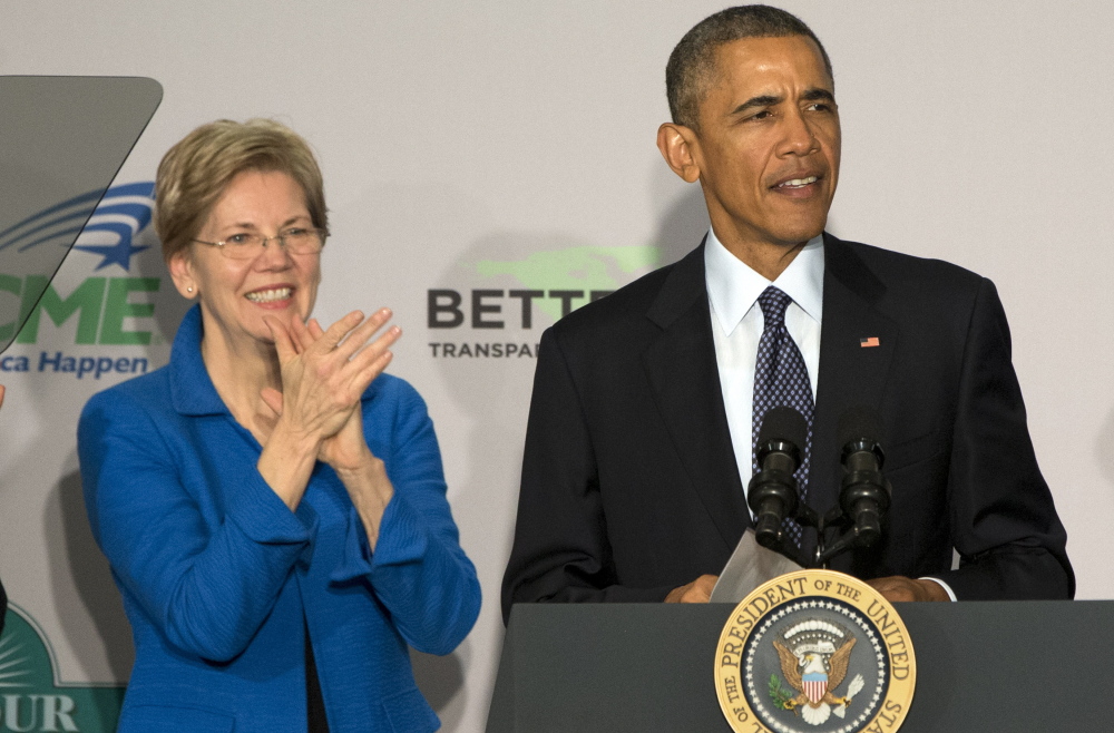 Sen. Elizabeth Warren, D-Mass., applauds as President Obama arrives to speak at AARP in Washington on Feb. 23. Obama says his dispute with Warren over trade policy “has never been personal.”