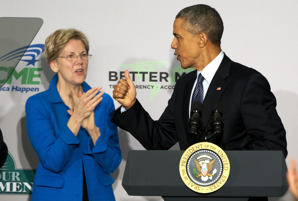 Sen. Elizabeth Warren, D-Mass., applauds as President Obama arrives at AARP in Washington on Feb. 23. Obama says his dispute with Warren over trade “has never been personal.”