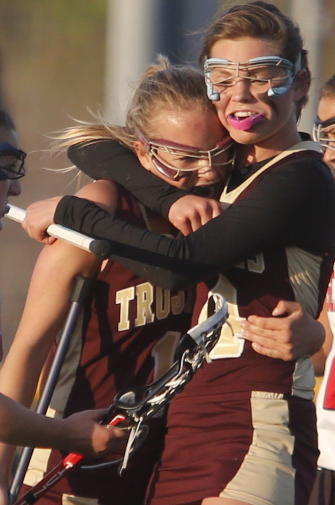 Paige LeBlanc of Thornton Academy gets a hug from teammate Faith Sinclair after scoring in the second half.