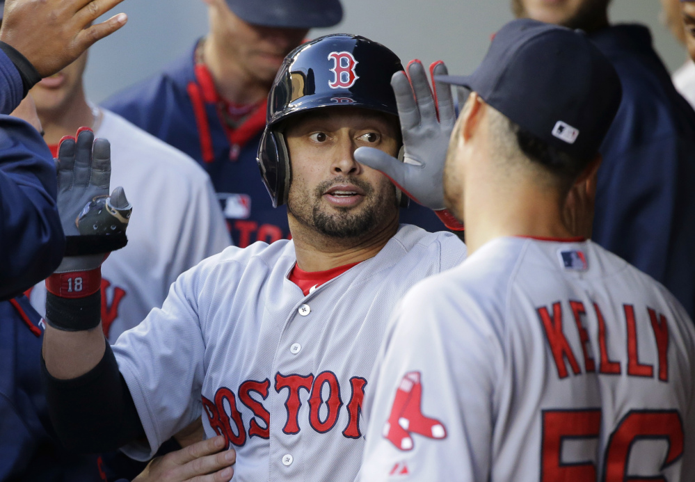 Shane Victorino of the Red Sox is greeted by pitcher Joe Kelly after Victorino’s solo home run in Boston’s game in Seattle late Thursday night. The Red Sox won, 2-1.