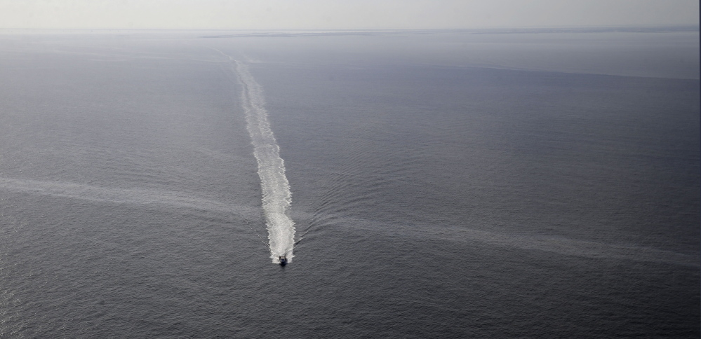 A vessel crosses an oil sheen March 31 drifting from the site of the former Taylor Energy oil rig in the Gulf of Mexico.