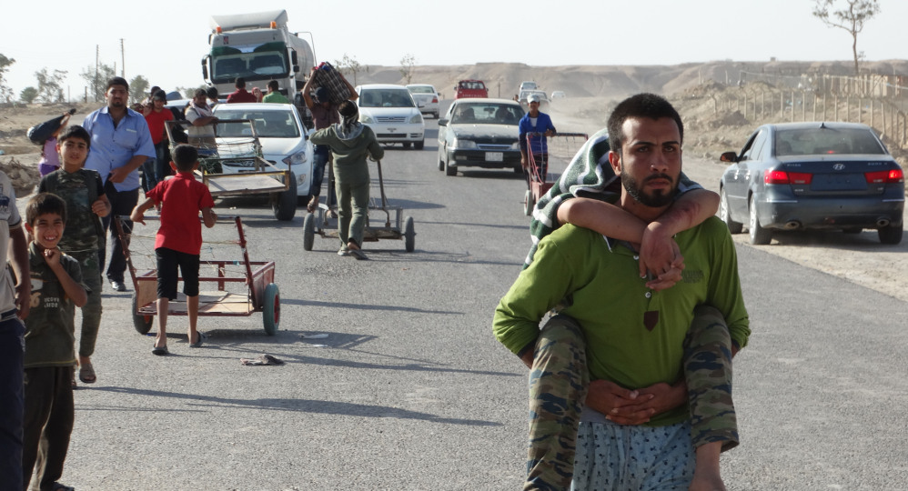 Iraqi family members who left their hometown of Ramadi walk toward Baghdad, about 70 miles away.