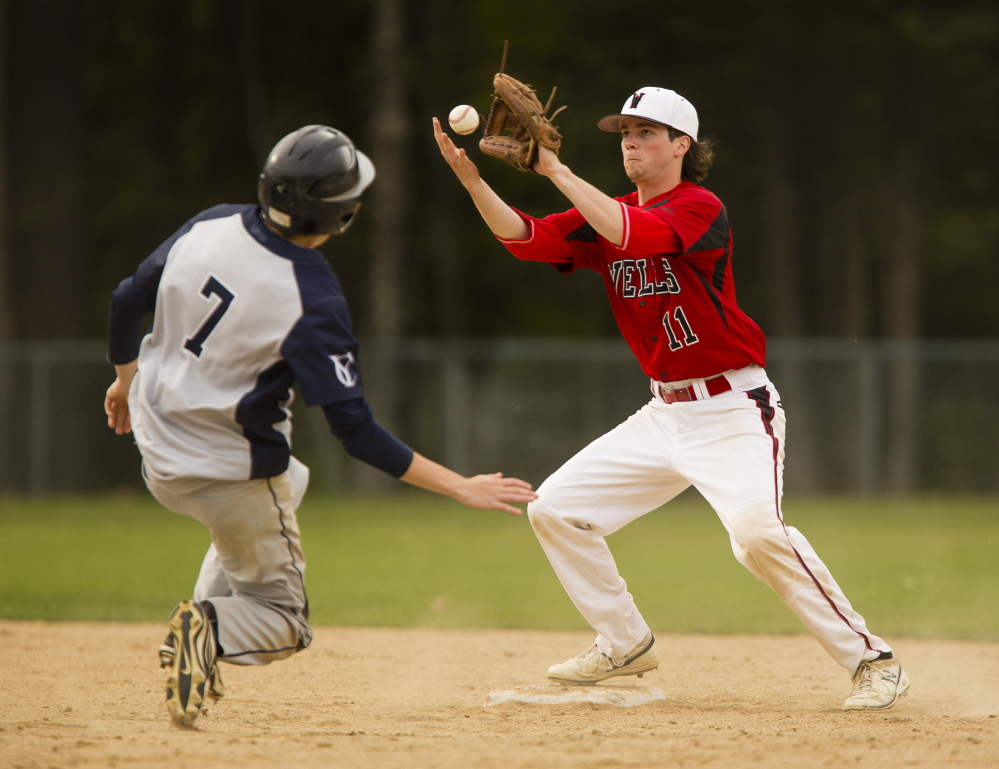 Caleb Gray of Yarmouth slides safely into second base as Wells shortstop Dan Quint attempts to control the ball on a force play. Carl D. Walsh/Staff Photographer