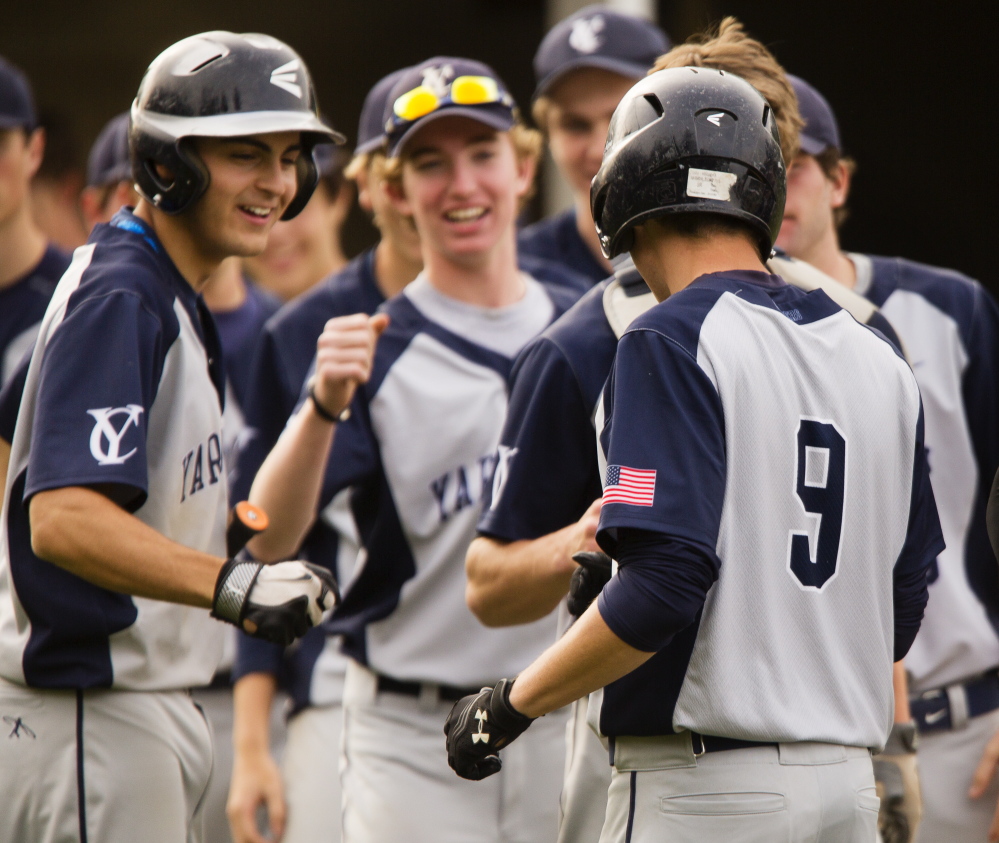 The Yarmouth High baseball players celebrate Friday during a five-run fourth inning that made the difference in a 7-4 victory at home against Wells in a Western Maine Conference game.