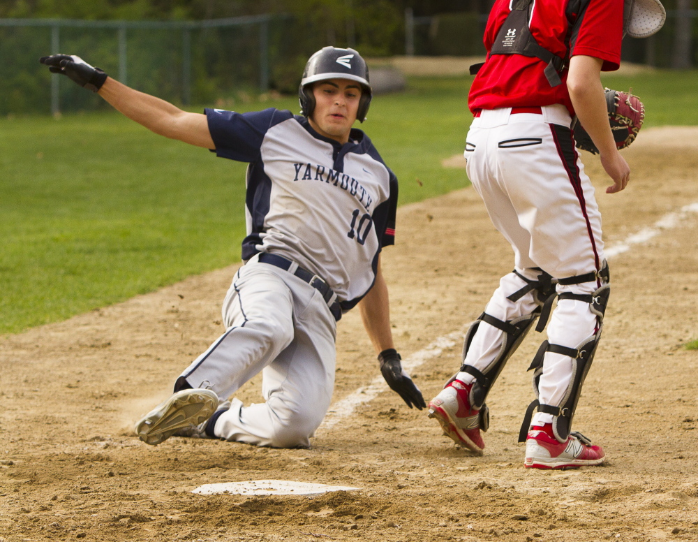 Cody Cook of Yarmouth slides safely across the plate Friday, scoring on a Jordan Brown single during the five-run fourth inning in a 7-4 victory against Wells. Carl D. Walsh/Staff Photographer