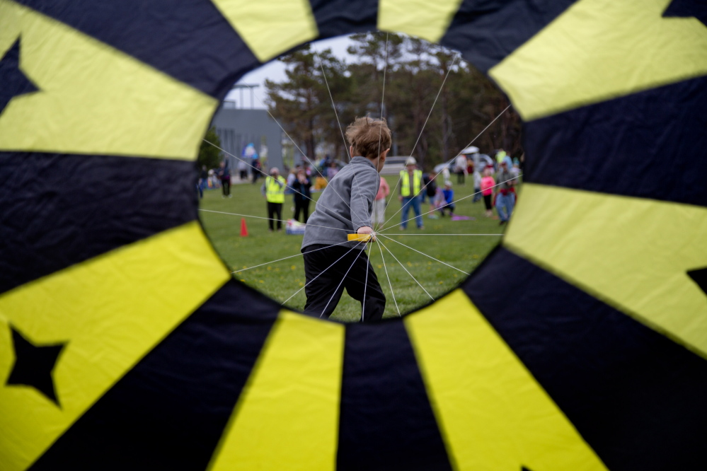 Felix Correia, 5, of South Portland pulls a “bol kite” – kind of like a parachute with vents – during a race. Bol kites’ greater wind resistance makes running more difficult.