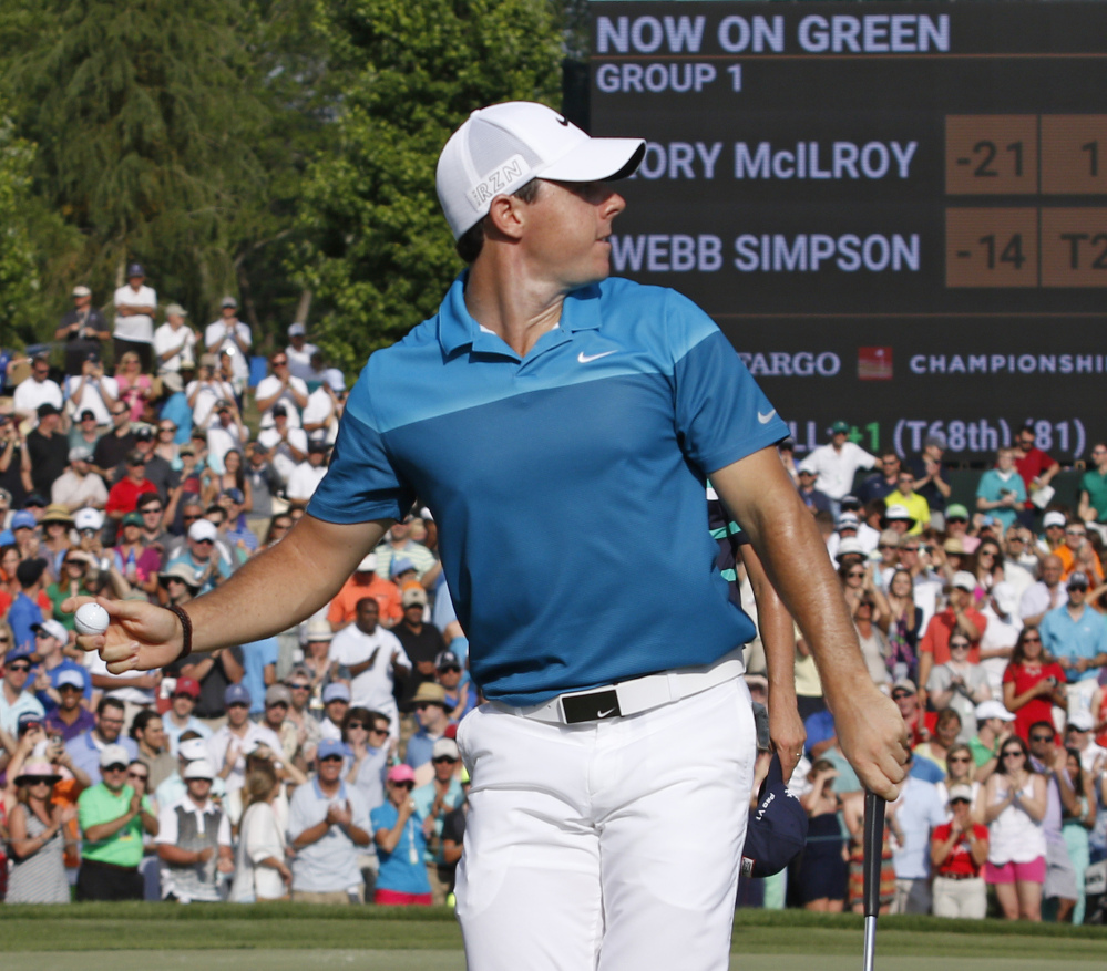 Rory McIlroy celebrates his win Sunday at the Wells Fargo Championship by throwing his golf ball into the crowd of fans around the 18th hole. McIlroy cruised to his second straight PGA Tour victory, winning by seven strokes.