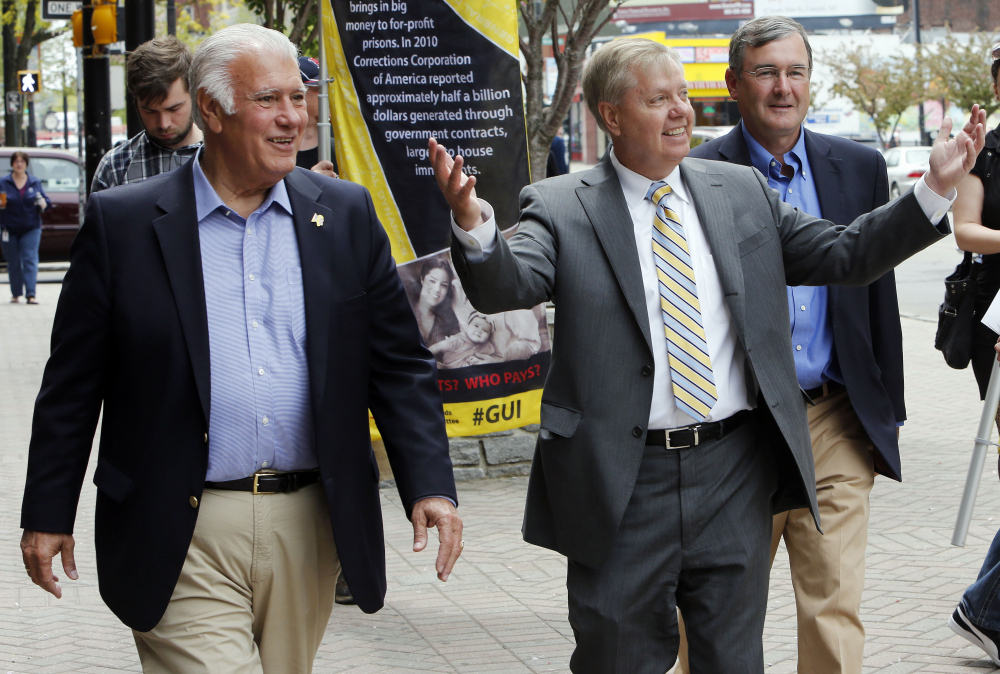 Sen. Lindsey Graham, R-S.C., accompanied by Manchester, N.H., Mayor Ted Gatsas, takes a walking tour of downtown Manchester, N.H., Friday, May 15, 2015. Graham is considering a run for the Republican nomination for president.