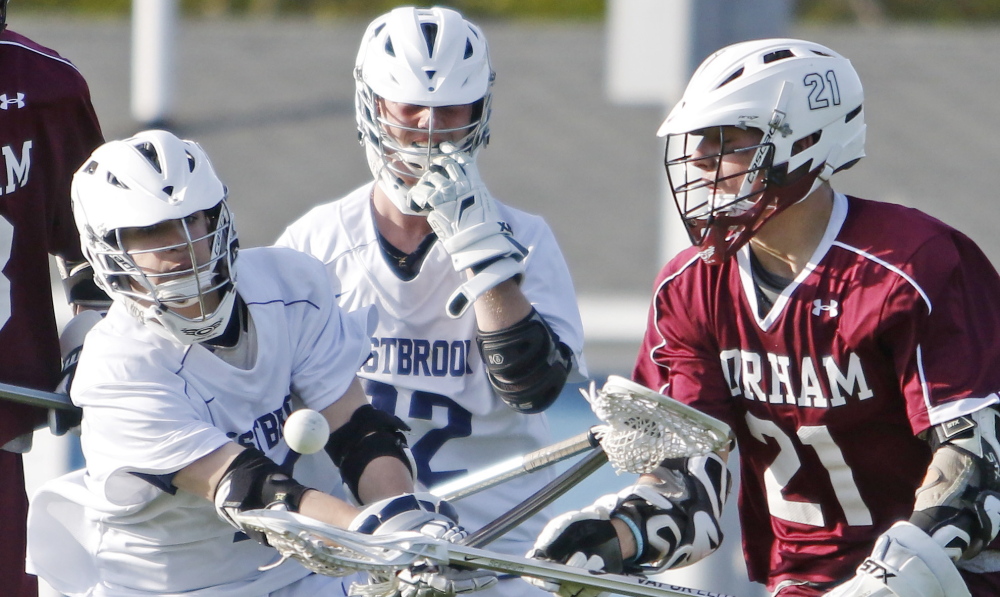 Stephen Shackley, left, and Gorham’s Michael Susi battle for possession during the second half of Monday’s boys’ lacrosse game at Westbrook. The Blue Blazes got off to a quick start in winning 9-7.