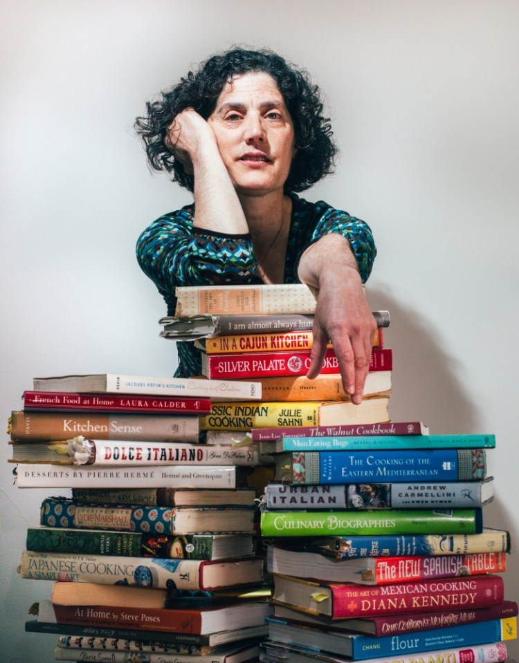 Peggy Grodinsky, with a fraction of her cookbook collection.