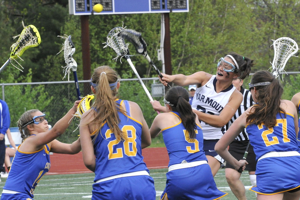 Shannon Fallon of Yarmouth unleashes a shot while surrounded by the Lake Region defense, scoring one of her five goals in a 19-8 victory Tuesday. The defenders from left are Olivia Deschenes, Katie Throgmorton, Aisley Sturk and Nicole Fox.