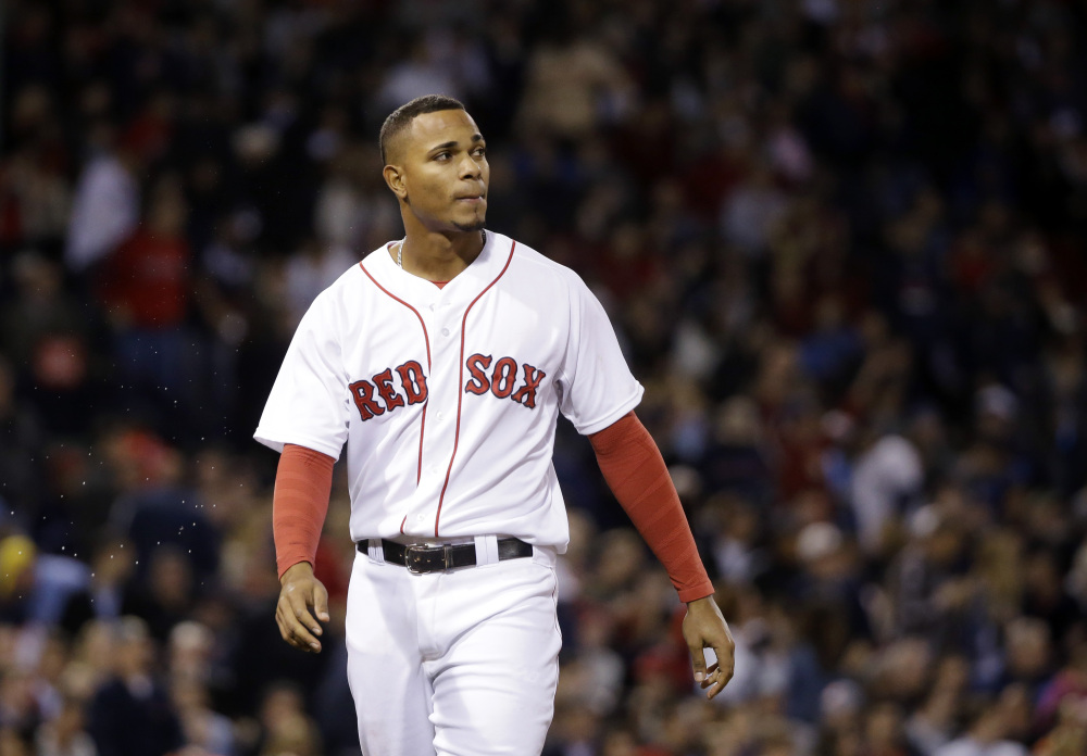 Boston’s Xander Bogaerts watches the replay after lining out with the bases loaded to end the sixth inning of Wednesday night’s game at Fenway Park. The Red Sox left 12 runners on base in the 2-1 loss to the Texas Rangers.
