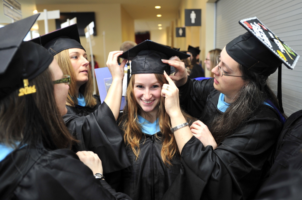 Sarah Quint of Wells, center, Krista Chamberlain of Buxton, second from left, and Melissa Adams of Biddeford, prepare for graduation from USM at the Cumberland County Civic Center on May 10. A recent survey found that only 12 percent of new graduates have definite plans.
They are all getting a Masters in Teaching and Learning.