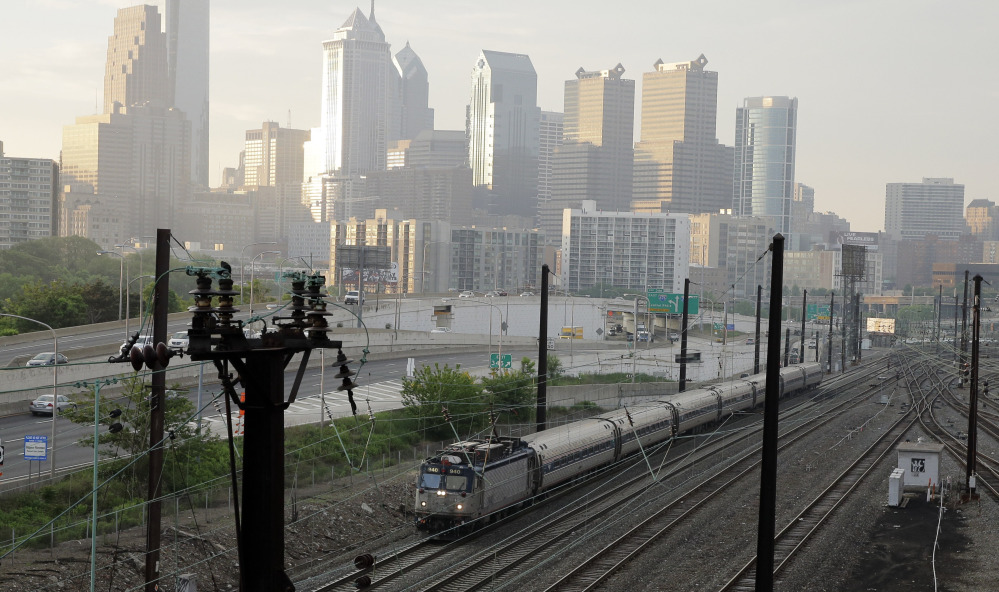 An Amtrak train travels north from 30th Street Station in Philadelphia. Amtrak’s Northeast Corridor trains resumed service Monday.