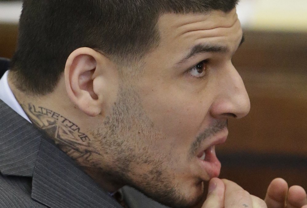 Former New England Patriots football player Aaron Hernandez, sporting a new neck tattoo, made a court appearance Thursday in Boston. He plead not guilty of trying to silence a witness in a 2012 double-murder case.
